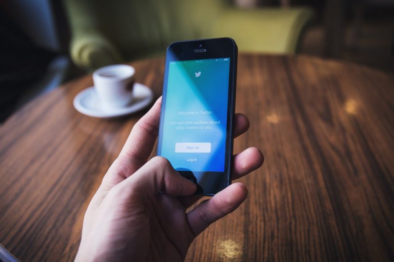 Man on mobile phone looking at Twitter