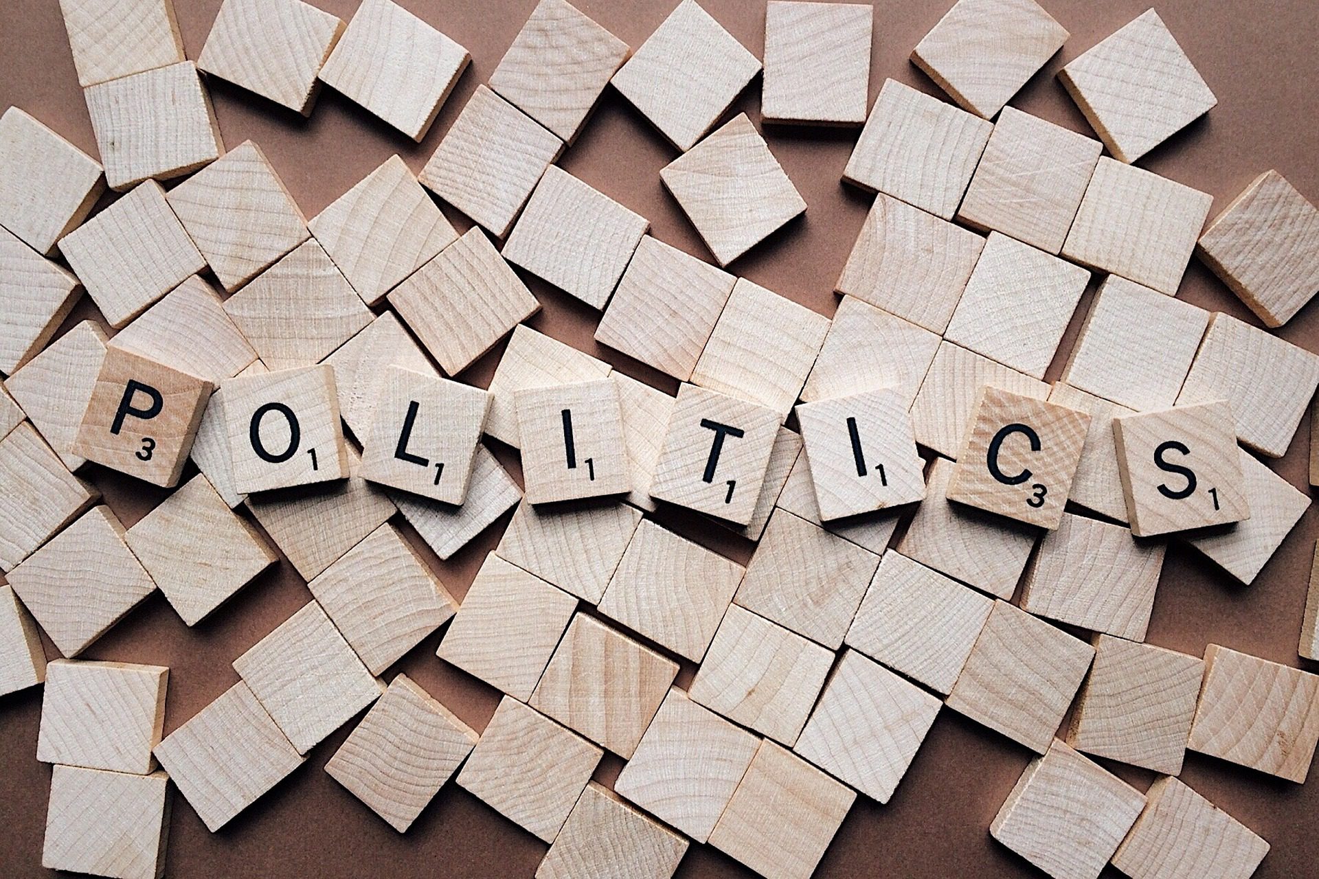 Wooden Scrabble tiles forming the word 'Politics'