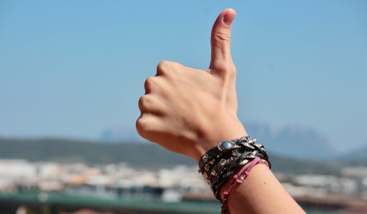 A photo of a hand giving a thumbs up