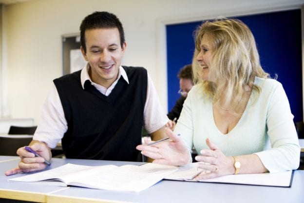 Photo of college tutor helping student