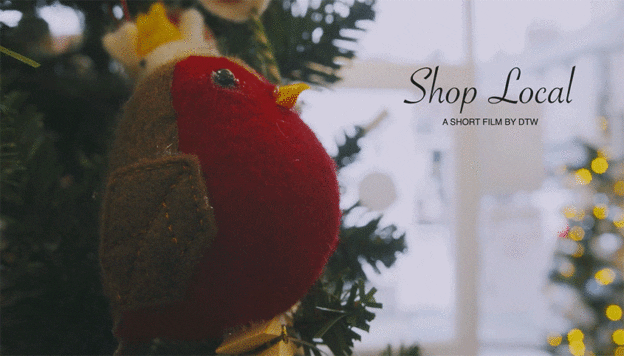 Screenshot from 'Shop Local' promo film showing fat robin felt bauble in local store