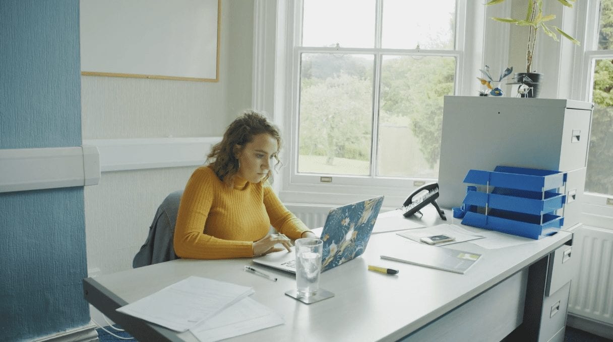Photograph of Emma working at a desk in DTW office