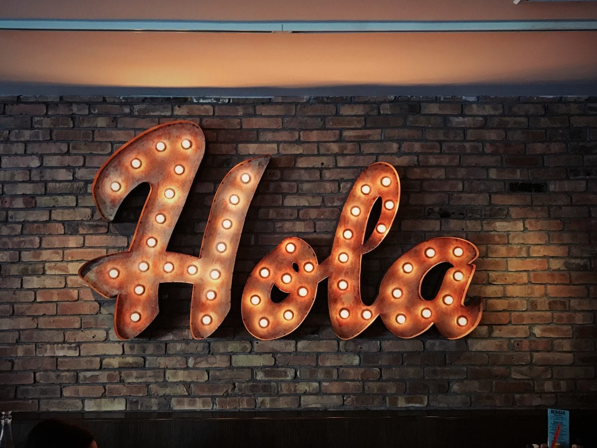 Illuminated wall sign in the shape of the word 'Hola'
