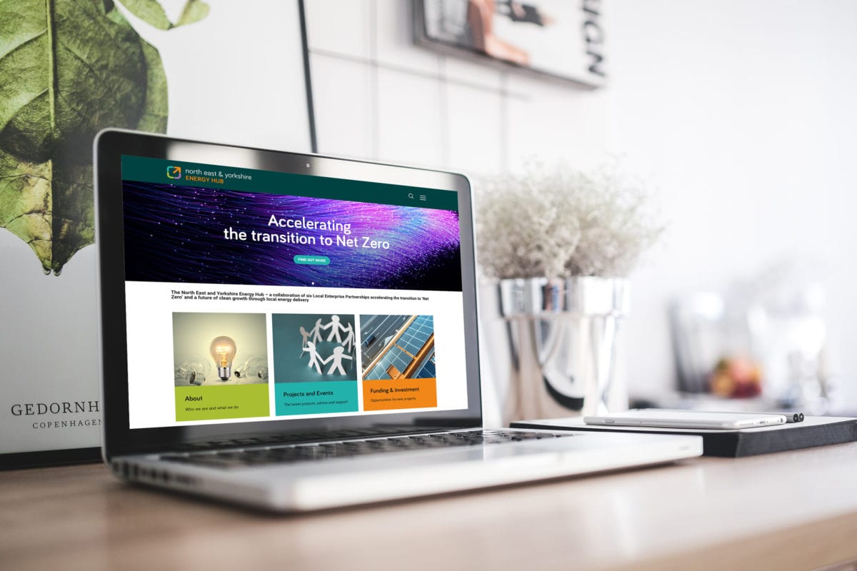 NEY Net Zero Hub website on a laptop in a bright modern home