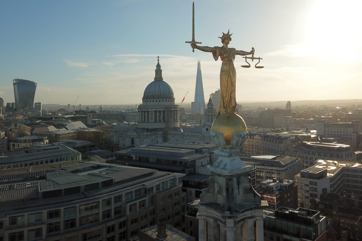 Photo of the gold statue of Lady Justice on top of the Old Bailey, London