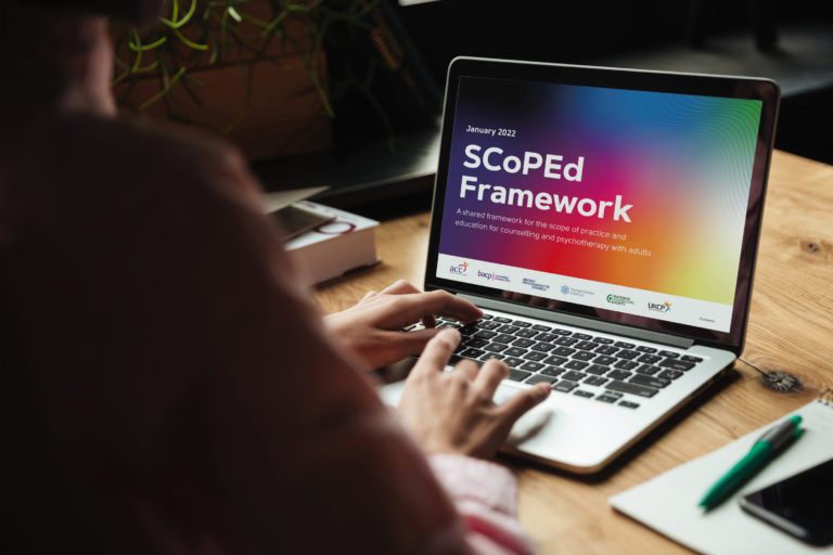 Person viewing the SCoPed Framework document on a laptop