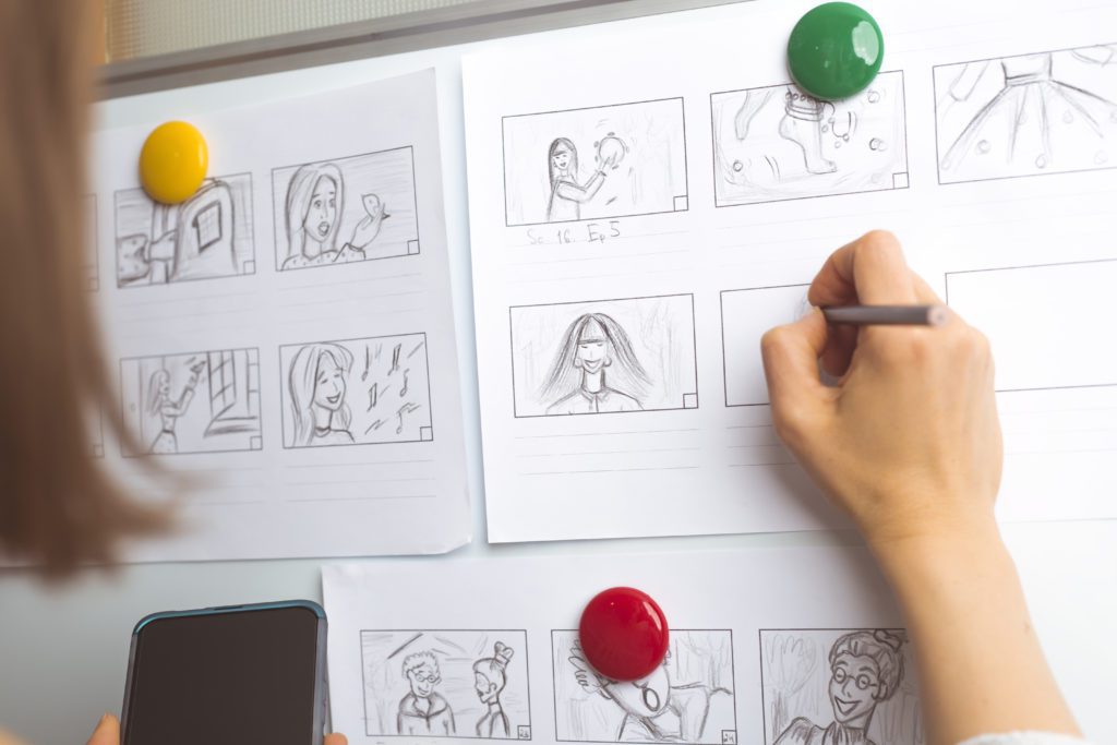 Photo of a woman drawing out a storyboard for animation or video
